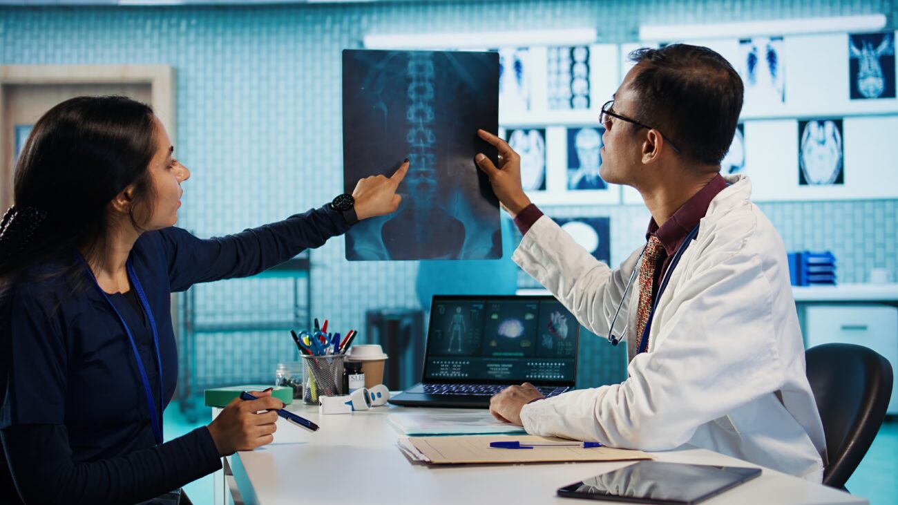 Radiology student reviewing digital scans on a clinical workstation during post-MBBS training