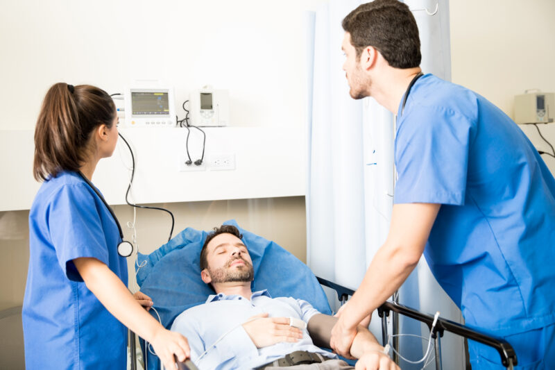 Doctor assessing trauma patient in the emergency department