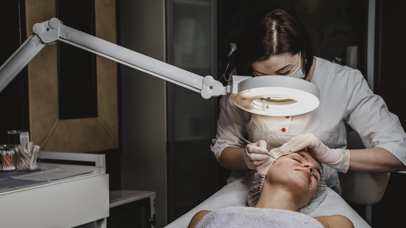 Doctor performing a cosmetic dermatology procedure in a clinical setting, representing the shift from medical dermatology to aesthetic practice